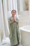 aisha kaftan dress sage green on model 3