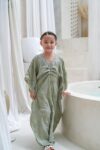 aisha kaftan dress sage green on model 3
