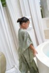 aisha kaftan dress sage green on model 3